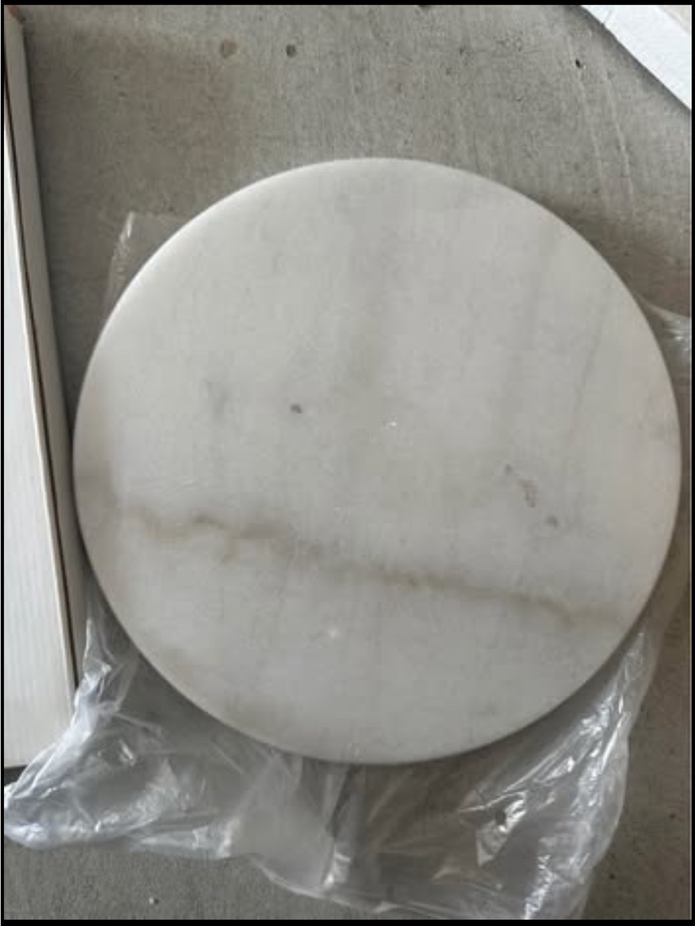 Solid marble turntable with a white and grey veined pattern. Size is 10.5